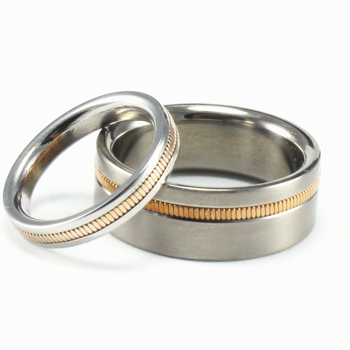 A set of titanium rings featuring guitar strings embedded into a channel encircling each ring.