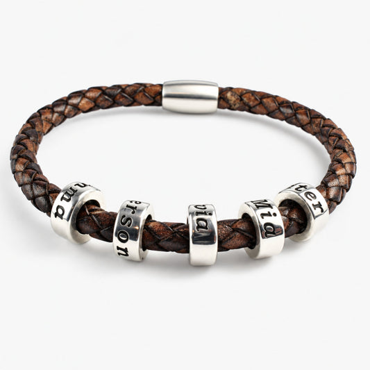 An antique brown genuine leather braided bracelet with 5 personalized sterling silver beads, on a white background