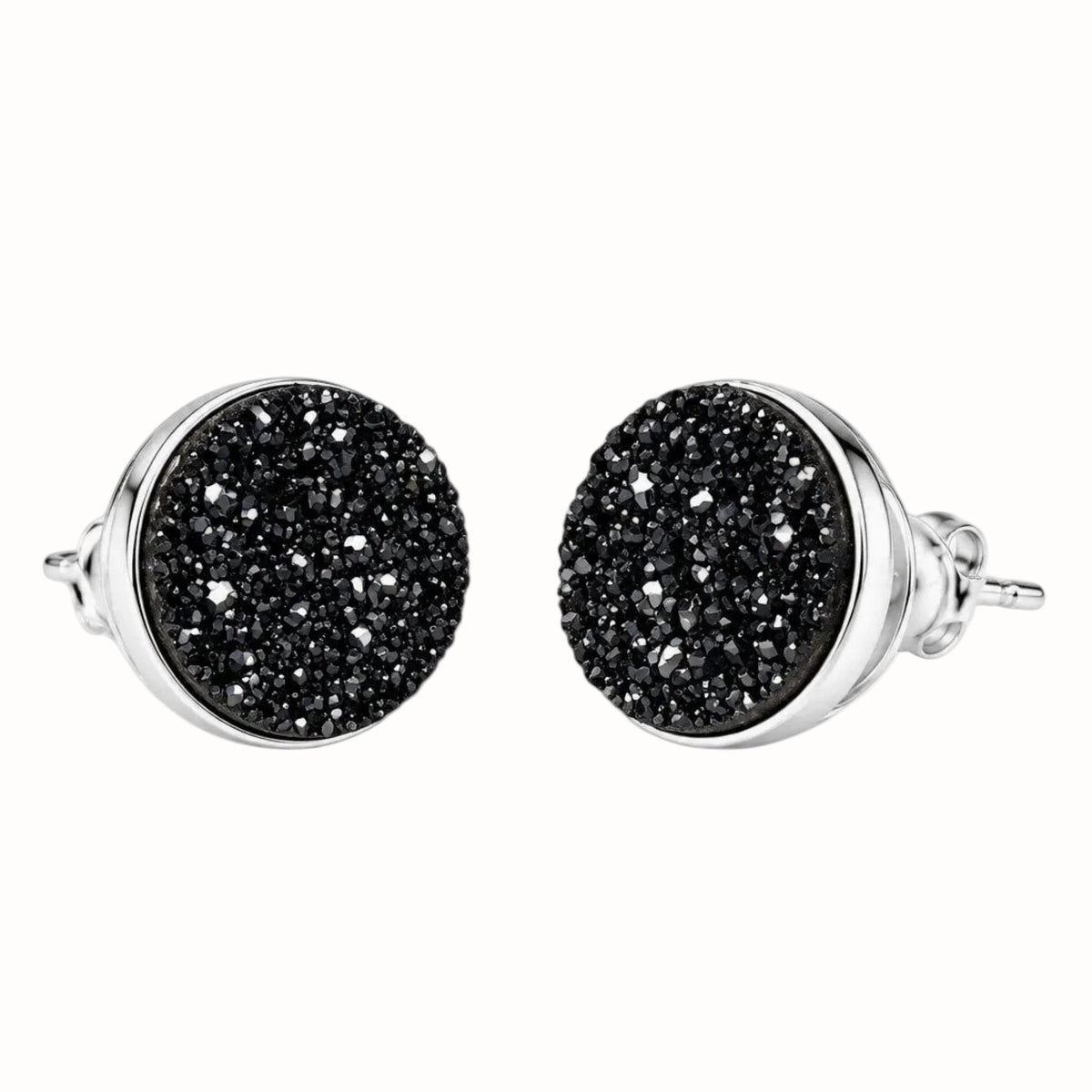 A pair of round stud earrings with textured black druzy faces and polished sterling silver bezels and posts, shown against a light gray background.