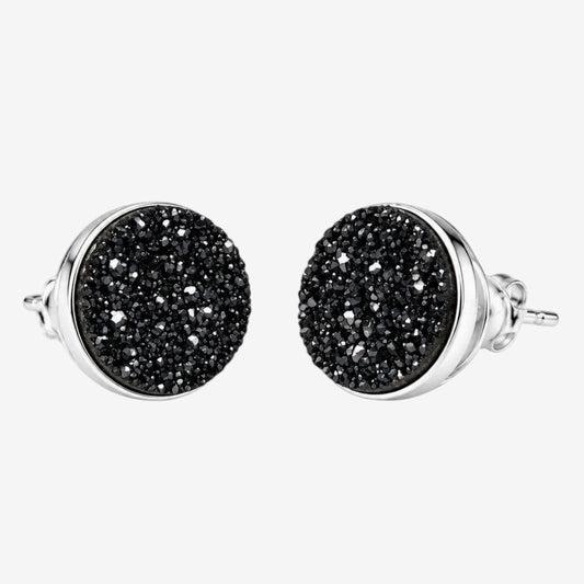 A pair of round stud earrings with textured black druzy faces and polished sterling silver bezels and posts, shown against a light gray background.