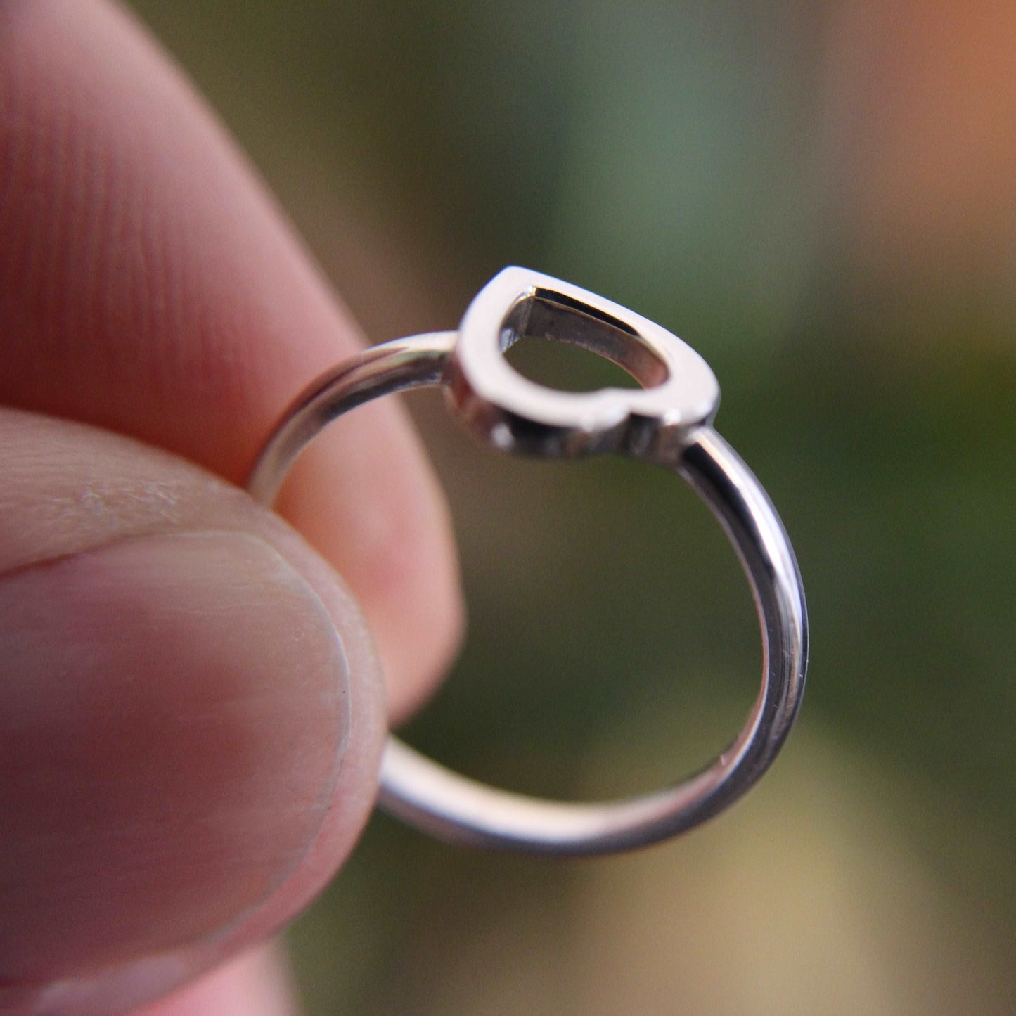 Heart Ring Sterling Silver 925 being held with 2 fingers
