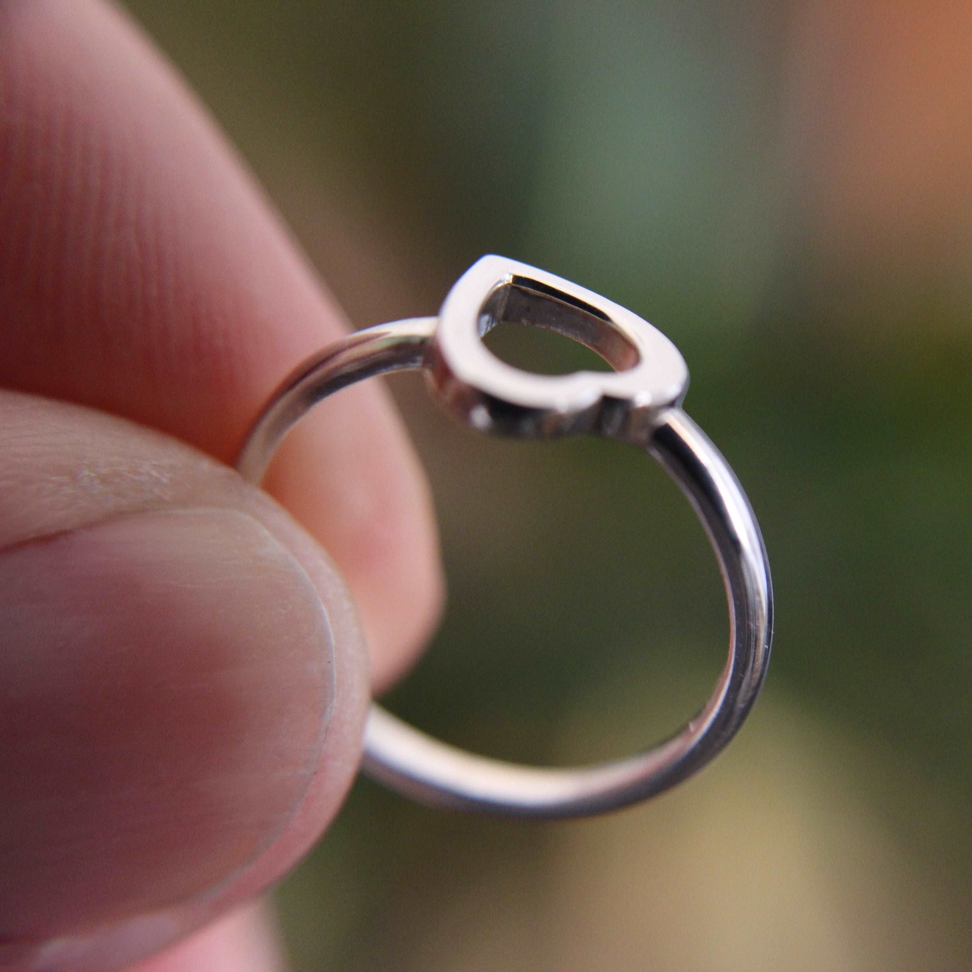 Heart Ring Sterling Silver 925 being held with 2 fingers