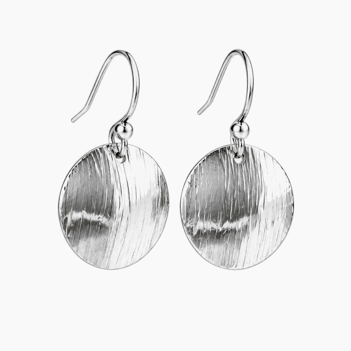 A pair of textured silver drop earrings with circular disc pendants and fishhook ear wires, shown on a light gray background.