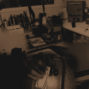 Dark and grainy image of a workshop with tools and equipment.