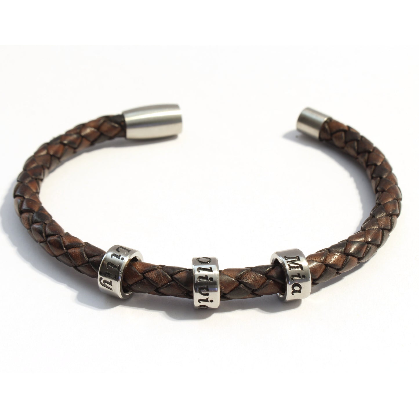 Antique Brown bolo braided leather bracelet 3 stainless steel beads with silver metal clasp on a white background
