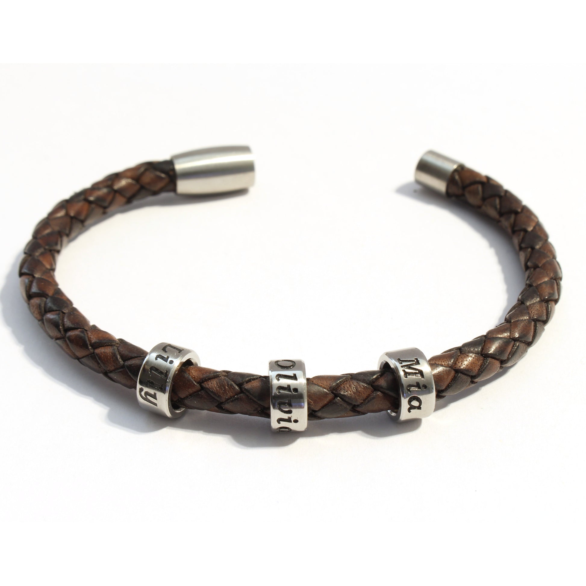 Antique Brown bolo braided leather bracelet 3 stainless steel beads with silver metal clasp on a white background