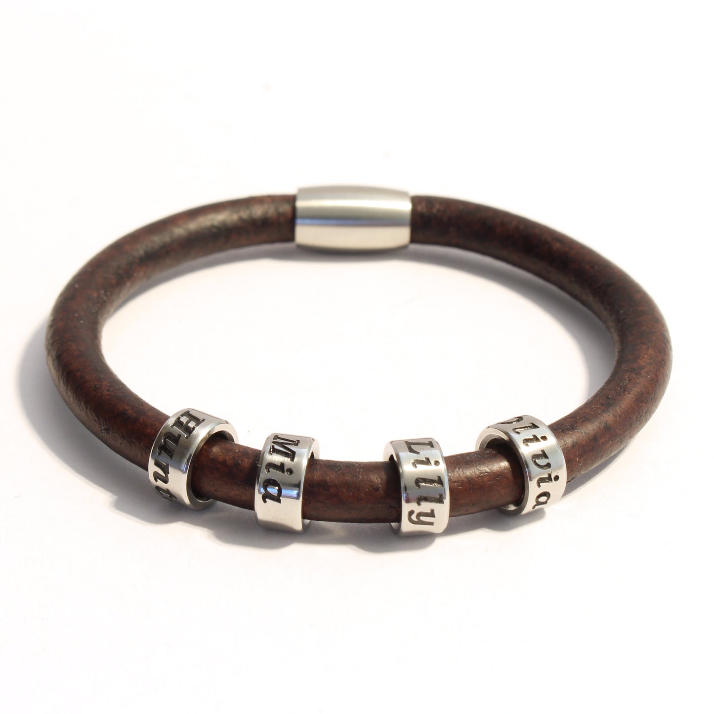 Brown leather bracelet with 4 stainless steel cylindrical beads on a white background