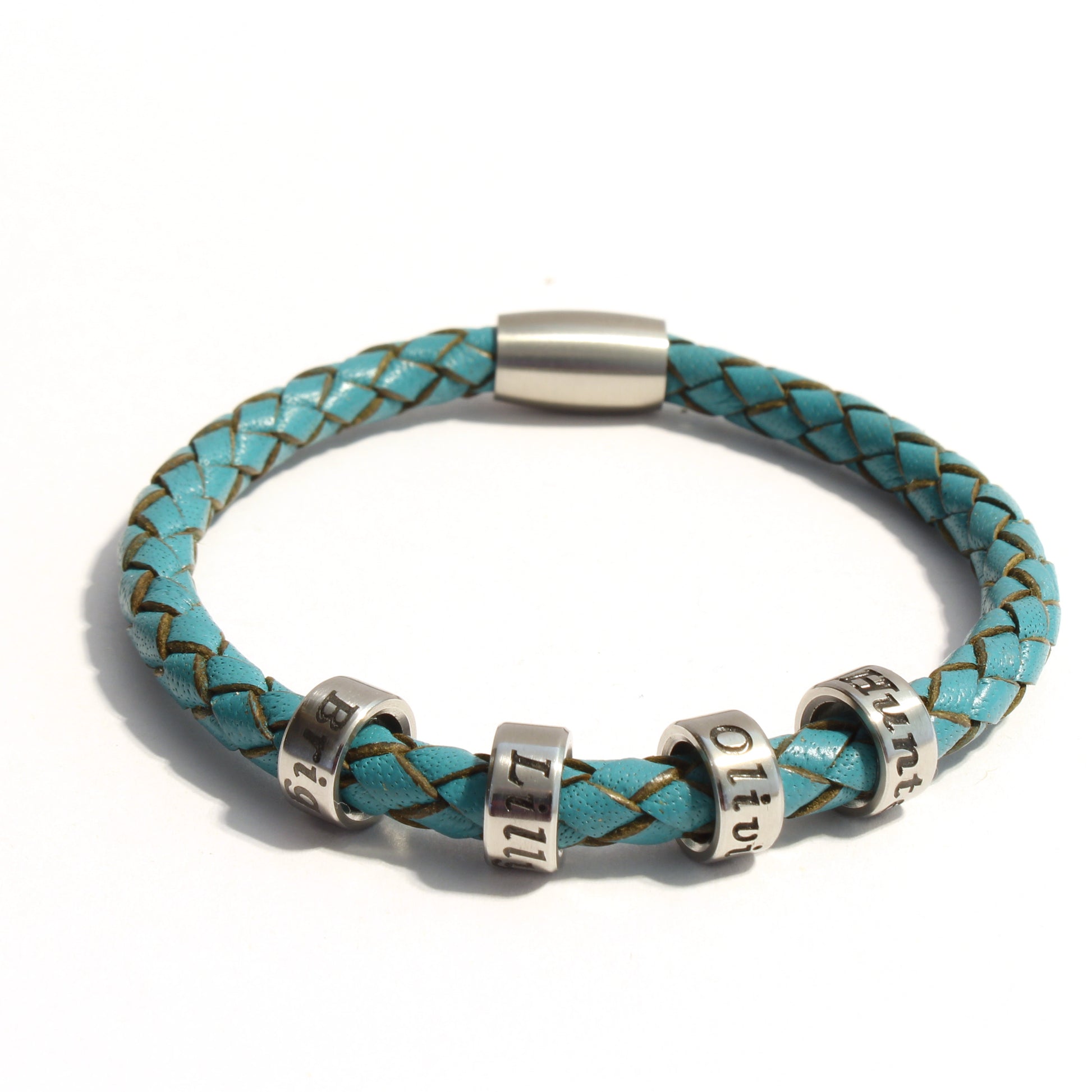 Turquoise braided leather bracelet with 4 stainless steel beads on a white background