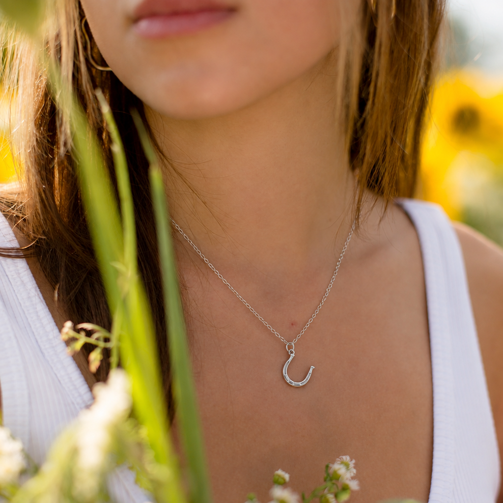 Model wearing the sterling silver horseshoe necklace
