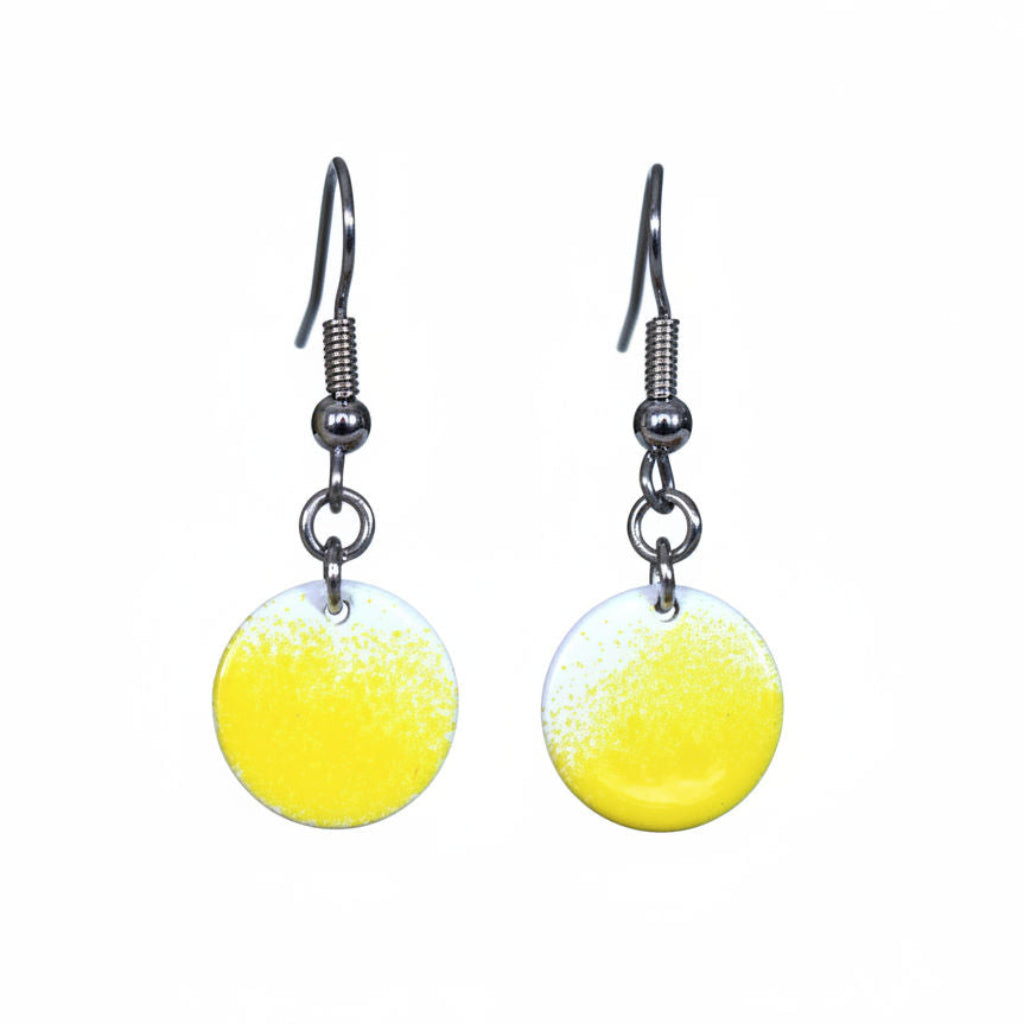 Yellow round earrings with silver hooks on a white background.