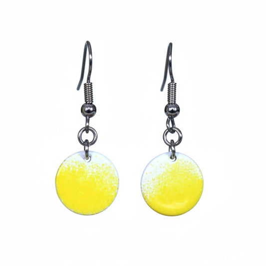 Yellow round earrings with silver hooks on a white background.
