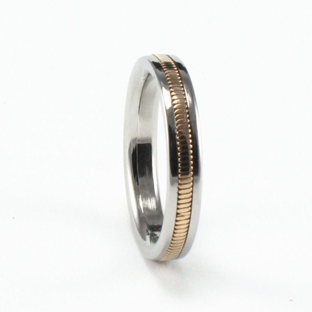 A guitar string ring with a narrow band and a phosphor bronze 6th E string inlay.